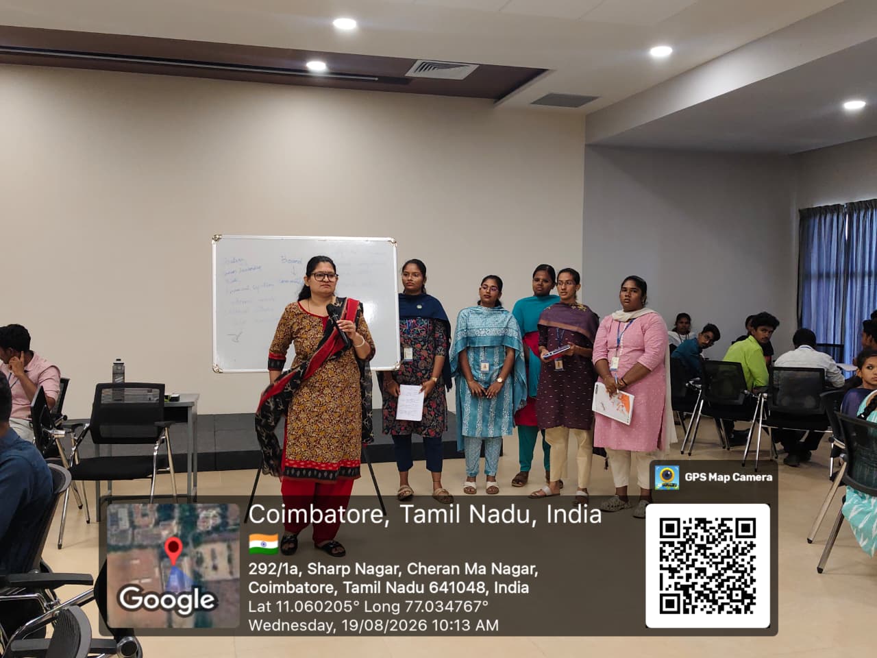 Janani Ramakrishnan standing with participants after a workshop activity