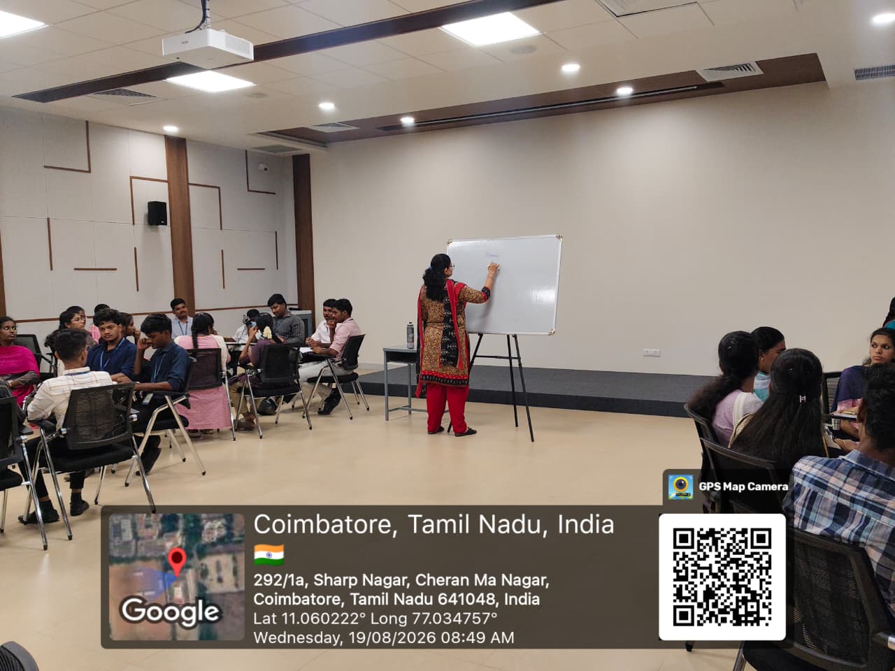 Janani Ramakrishnan writing on a whiteboard during a facilitation session